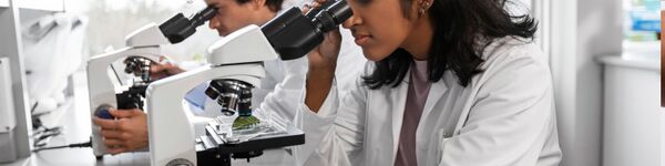 woman using microscope